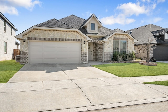 french country inspired facade featuring driveway, a garage, a shingled roof, brick siding, and a front yard