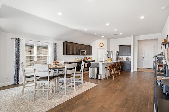 dining area with lofted ceiling, baseboards, dark wood-type flooring, and recessed lighting