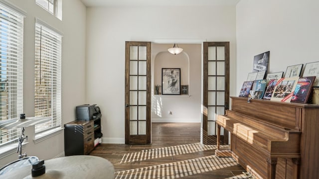 sitting room featuring dark wood-type flooring, french doors, and baseboards