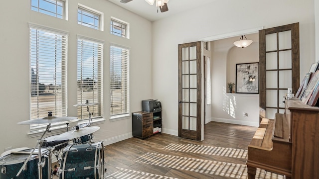 office space featuring dark wood-style flooring, a healthy amount of sunlight, and baseboards