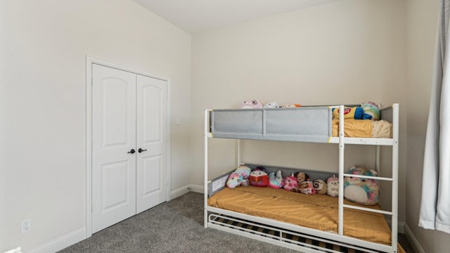 carpeted bedroom with baseboards and a closet