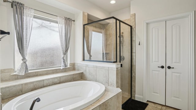 full bath featuring a closet, a wealth of natural light, and a stall shower