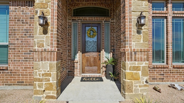 doorway to property with brick siding