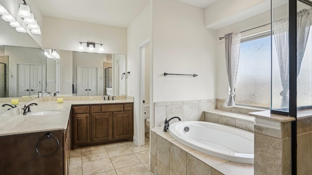 full bathroom with plenty of natural light, tile patterned flooring, and a sink