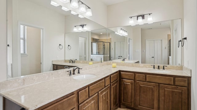 bathroom with a stall shower and a sink