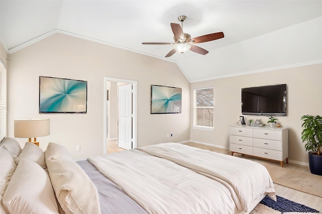 bedroom featuring a ceiling fan, baseboards, vaulted ceiling, light wood-type flooring, and crown molding