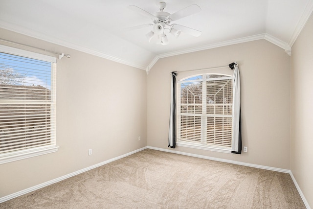 empty room featuring crown molding, light carpet, vaulted ceiling, ceiling fan, and baseboards