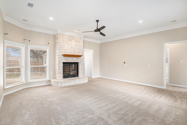 unfurnished living room with light carpet, a stone fireplace, visible vents, and crown molding