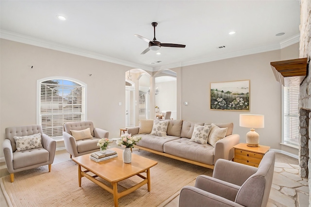 living area with arched walkways, recessed lighting, a ceiling fan, and crown molding