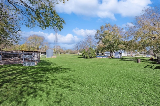 view of yard with an outbuilding and a shed