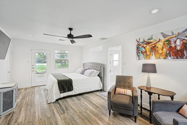 bedroom with ceiling fan, light wood-style floors, visible vents, and access to exterior