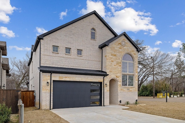 view of front facade with a garage, driveway, fence, and brick siding