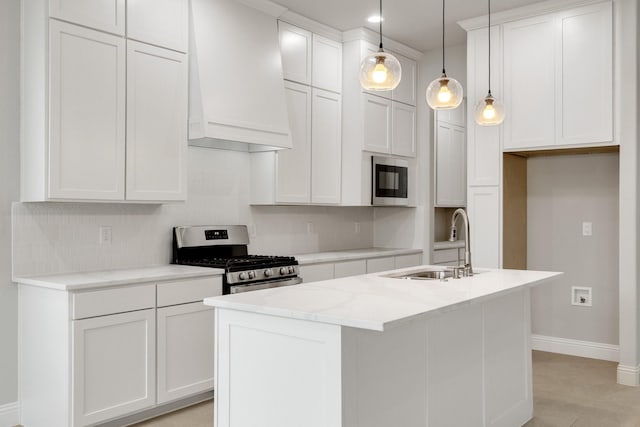 kitchen featuring white cabinets, custom range hood, a kitchen island with sink, stainless steel appliances, and pendant lighting