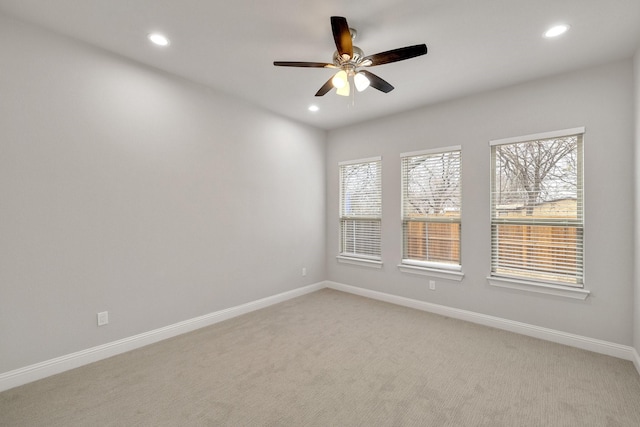 spare room with a wealth of natural light, recessed lighting, and baseboards