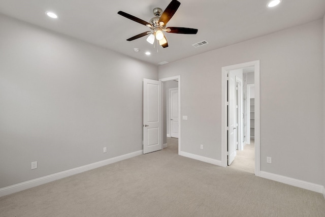 unfurnished bedroom featuring recessed lighting, visible vents, baseboards, and light colored carpet