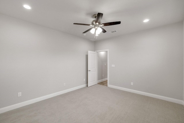 spare room with recessed lighting, visible vents, a ceiling fan, light carpet, and baseboards