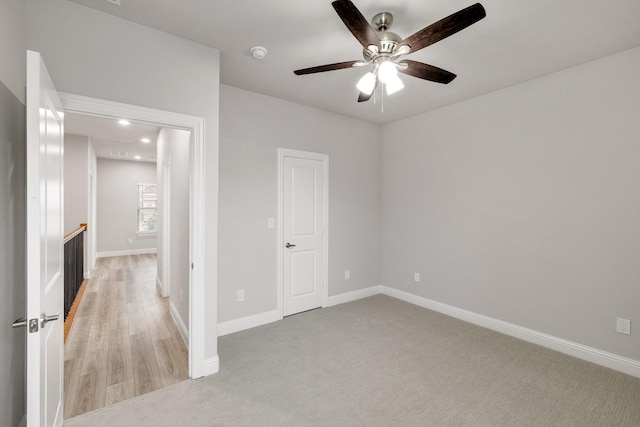 unfurnished bedroom featuring light carpet, ceiling fan, recessed lighting, and baseboards