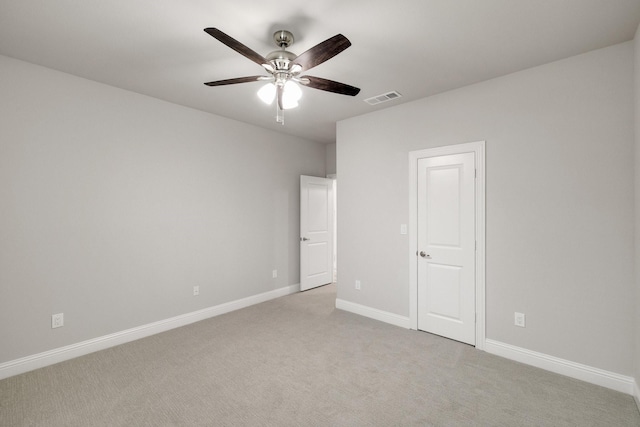 unfurnished bedroom with light colored carpet, visible vents, ceiling fan, and baseboards