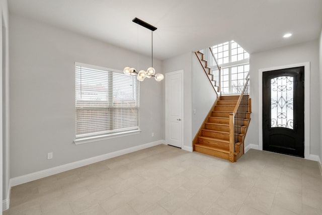 foyer featuring a chandelier, recessed lighting, baseboards, and stairs