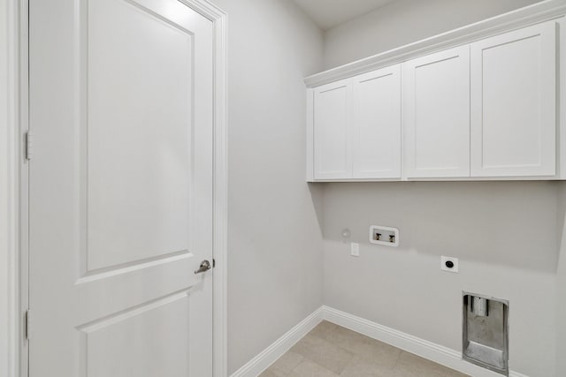 clothes washing area featuring hookup for a washing machine, cabinet space, gas dryer hookup, electric dryer hookup, and baseboards