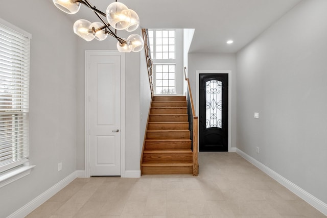 foyer entrance featuring stairs, recessed lighting, and baseboards