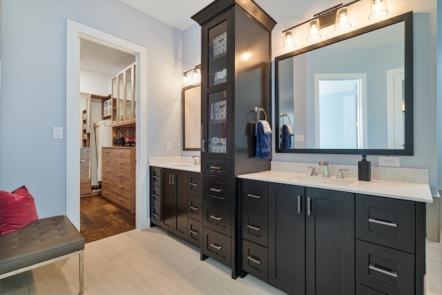 bathroom with a sink and double vanity