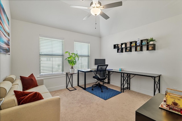 office area with ceiling fan, baseboards, vaulted ceiling, and light colored carpet