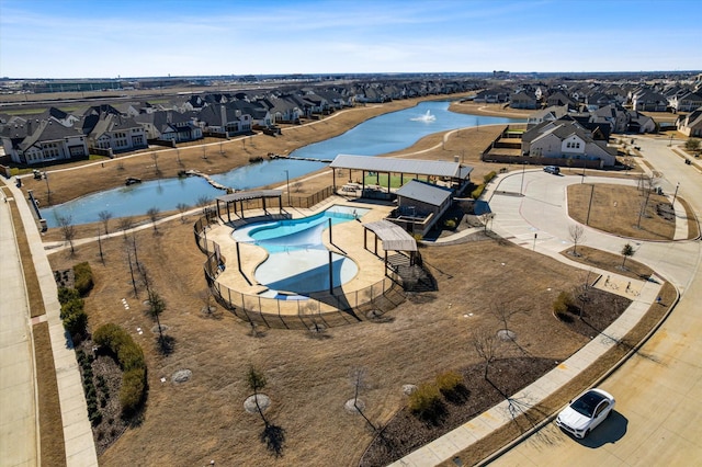 birds eye view of property featuring a water view and a residential view