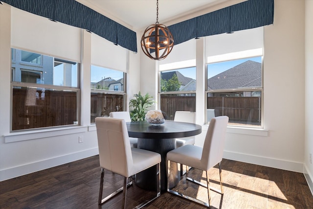 dining area with a chandelier, dark wood-style flooring, and baseboards