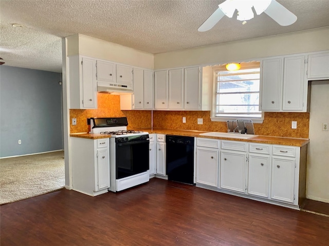 kitchen featuring under cabinet range hood, gas range, white cabinets, and black dishwasher