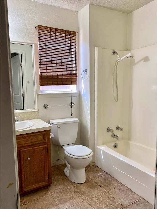 full bath featuring tile patterned flooring, a textured ceiling, vanity, and toilet