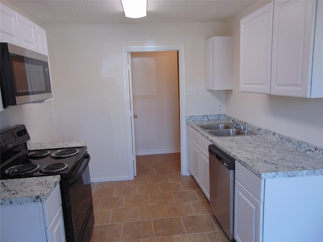 kitchen featuring stainless steel appliances, white cabinets, and a sink