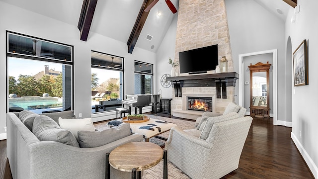 living room featuring beam ceiling, dark wood finished floors, a fireplace, high vaulted ceiling, and baseboards