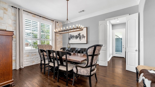 dining room featuring dark wood-type flooring, a notable chandelier, ornamental molding, and visible vents