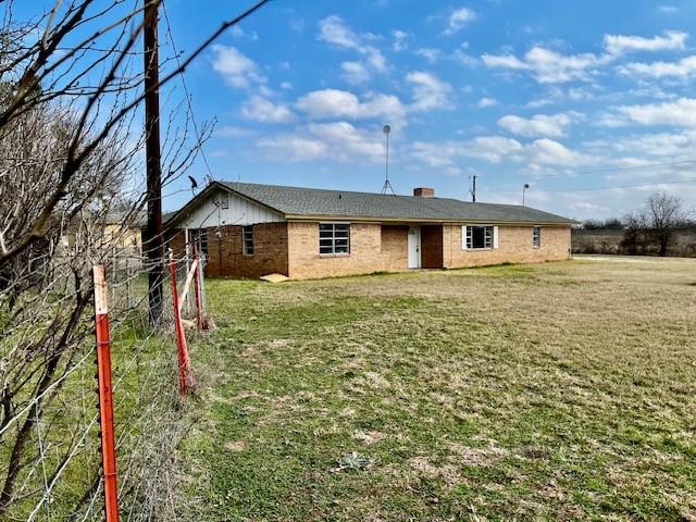 exterior space with a yard and a chimney