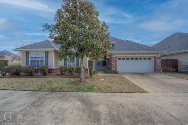 view of front of home featuring a garage, brick siding, concrete driveway, roof with shingles, and a front yard