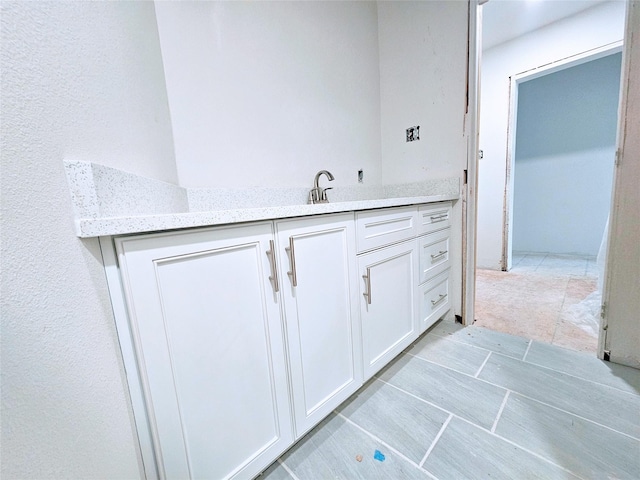 bathroom with a sink and tile patterned floors