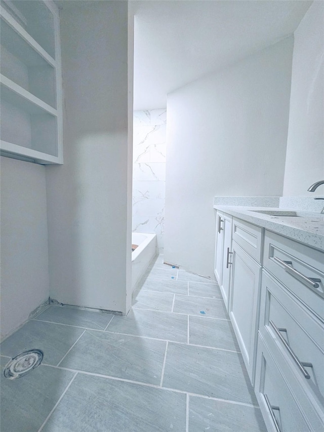 full bath with a tub to relax in and vanity