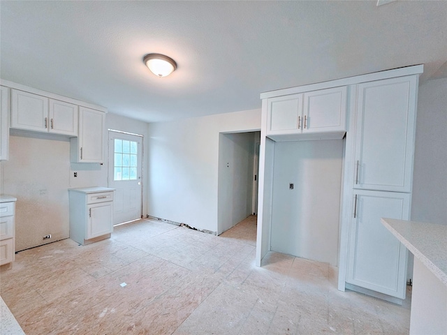 kitchen with white cabinets and light countertops