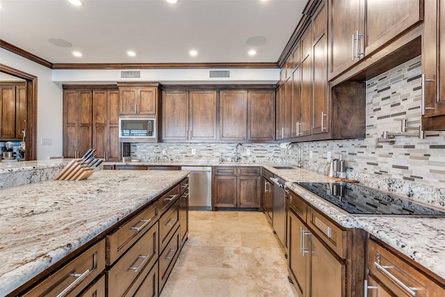 kitchen featuring built in microwave, black electric cooktop, visible vents, and light stone countertops