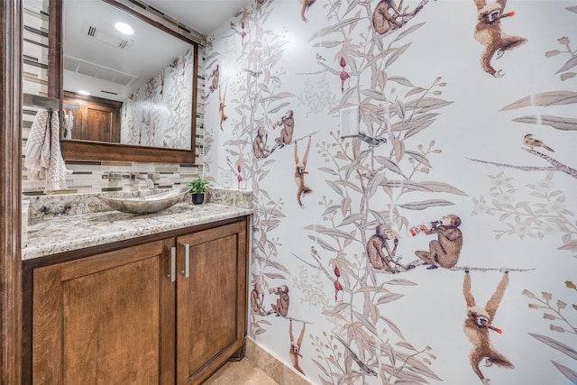 bathroom featuring visible vents, tasteful backsplash, and vanity