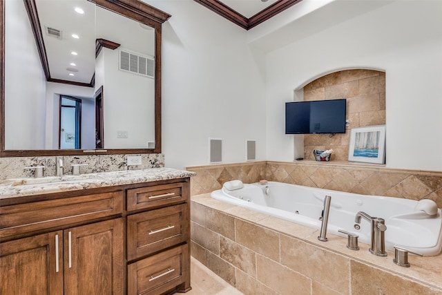 bathroom with a whirlpool tub, vanity, visible vents, and crown molding