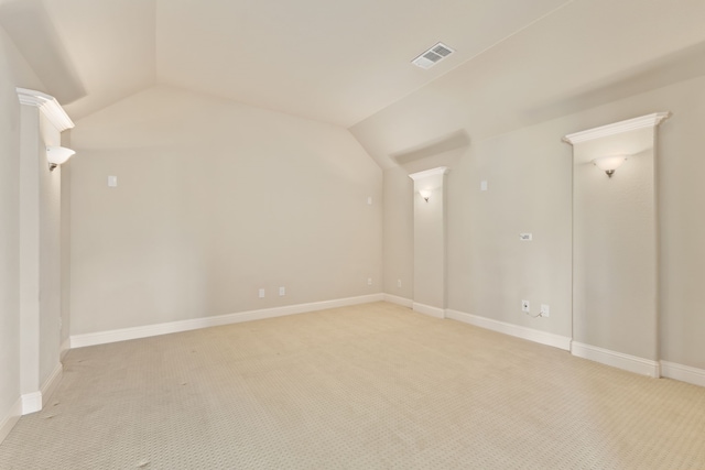 interior space featuring light carpet, lofted ceiling, visible vents, and baseboards