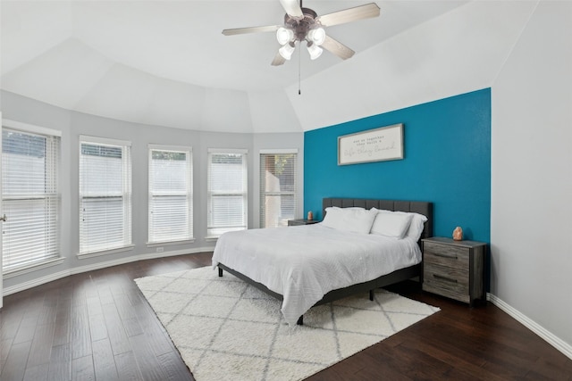 bedroom featuring a ceiling fan, dark wood-style flooring, vaulted ceiling, and baseboards