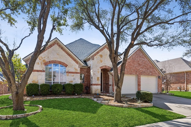 french provincial home with concrete driveway, stone siding, an attached garage, a front lawn, and brick siding