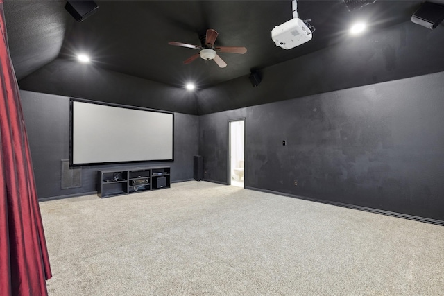 home theater room featuring vaulted ceiling, ceiling fan, and carpet flooring