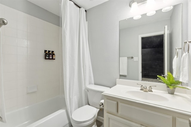 full bath with vanity, shower / bath combo with shower curtain, and toilet