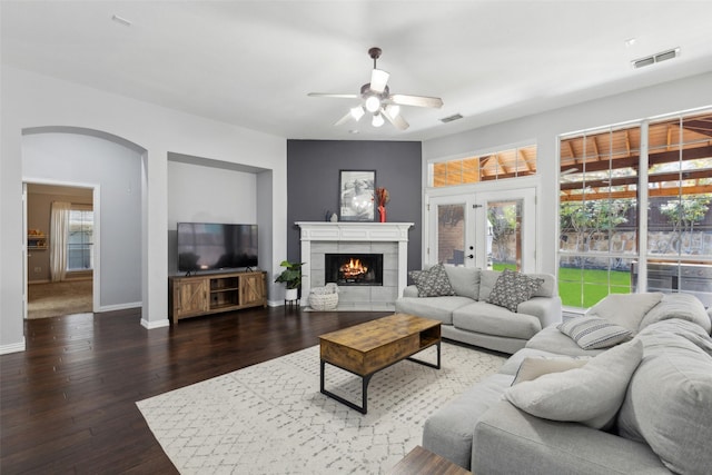 living area featuring plenty of natural light, visible vents, and dark wood finished floors