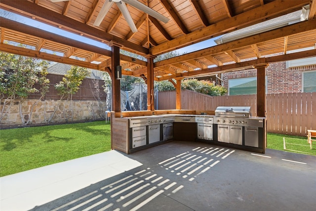 view of patio / terrace with a fenced backyard, a ceiling fan, and exterior kitchen