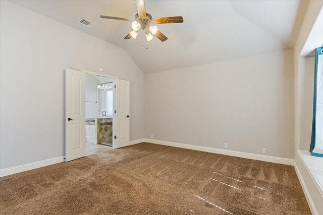 unfurnished bedroom with lofted ceiling, carpet flooring, visible vents, and baseboards